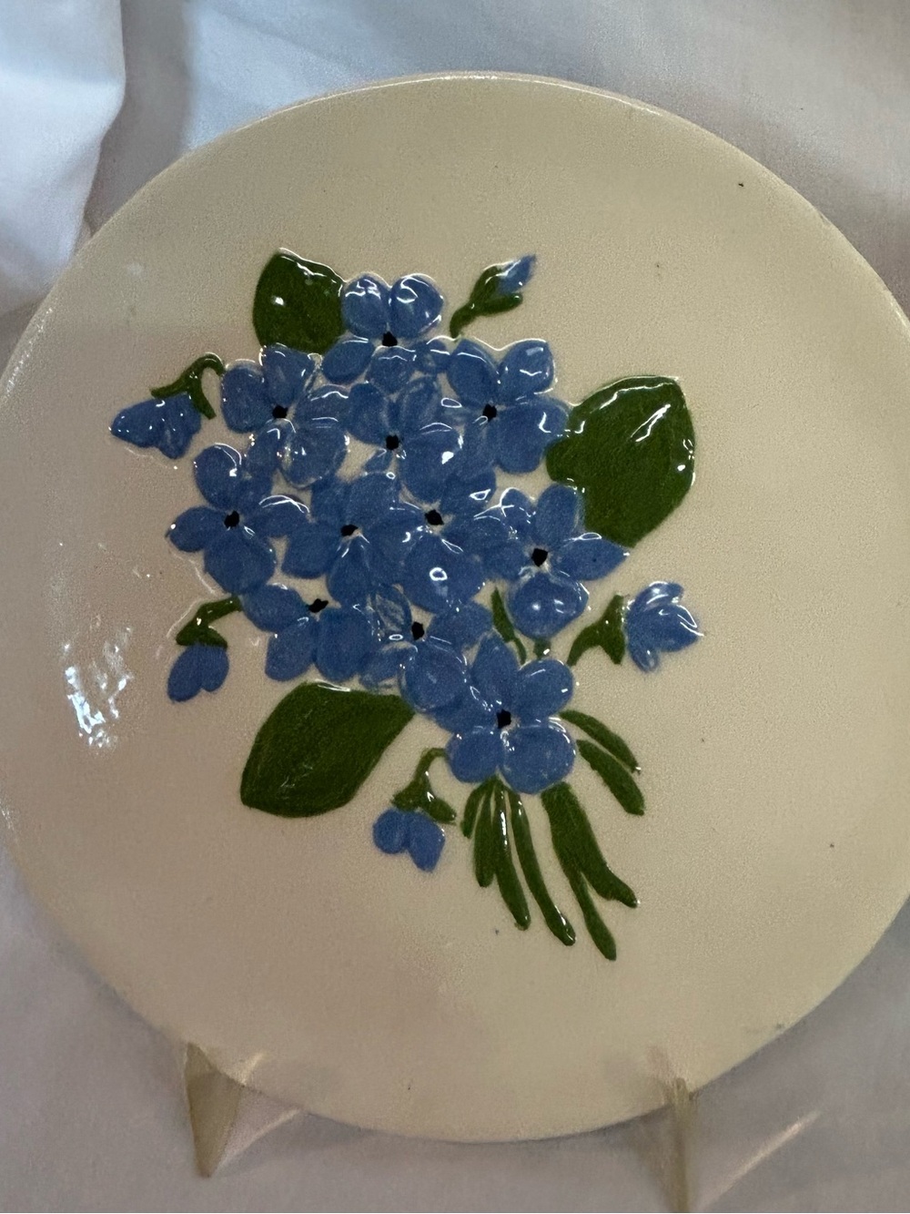 Three Hand-Painted Floral Ceramic Wall Plates. 8.25” diameter.